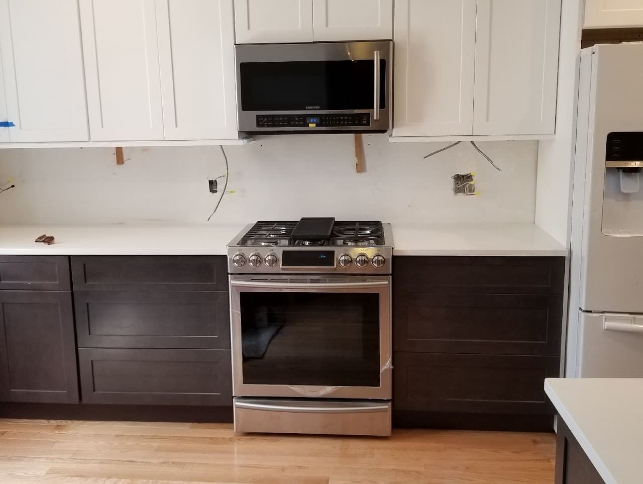 Finished kitchen with two-tone cabinetry and new appliances